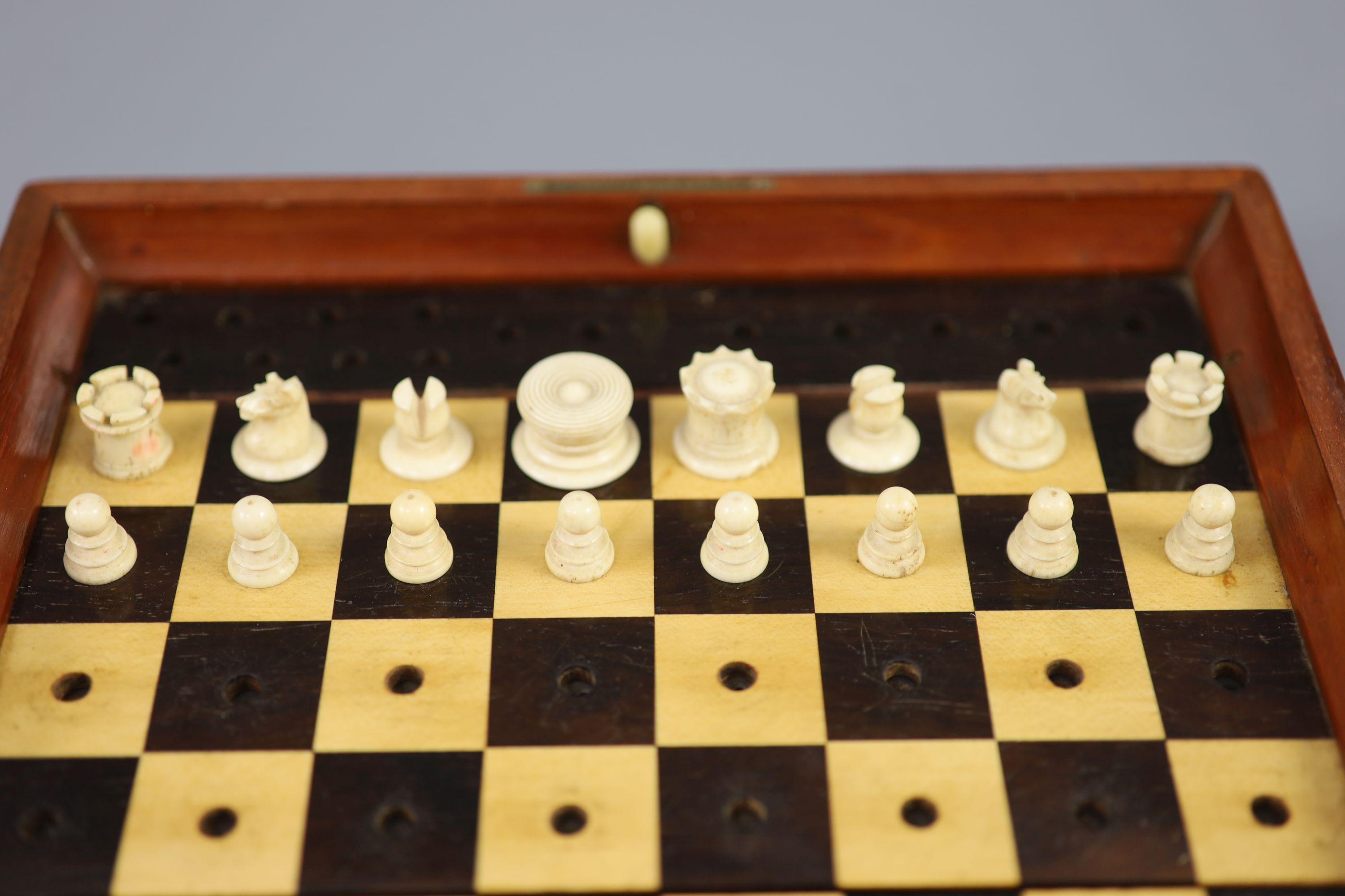 A Jaques & Son Ltd In Statu Quo bone travelling chess set, in mahogany case, c.1860, 9 x 5.5in.